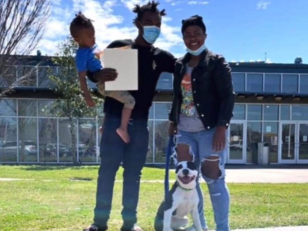 a man and a woman with a dog on a leash