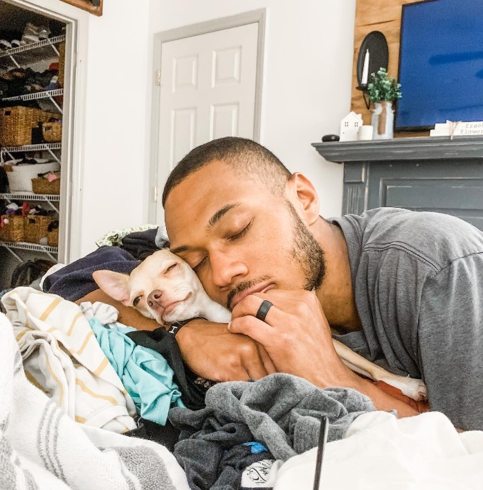 a man is petting a cute dog