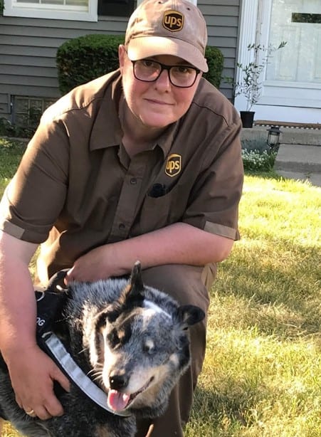 a man strokes a dog in the yard