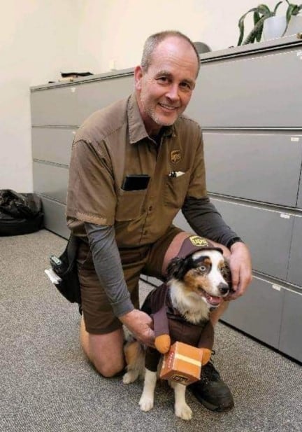 a man takes a picture with a dog in the ward