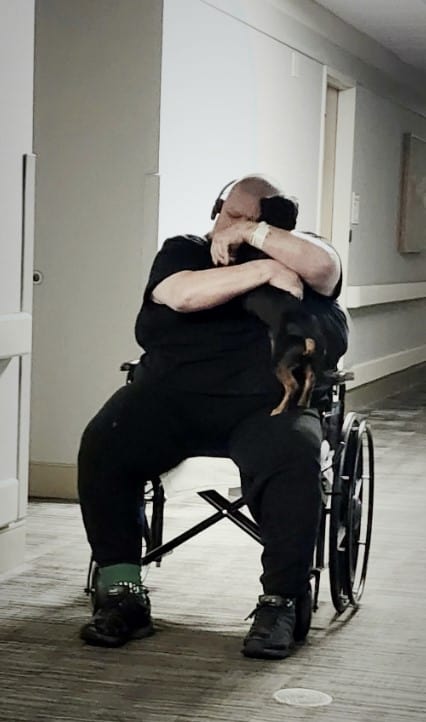 a man wakes up from a coma and hugs his dog