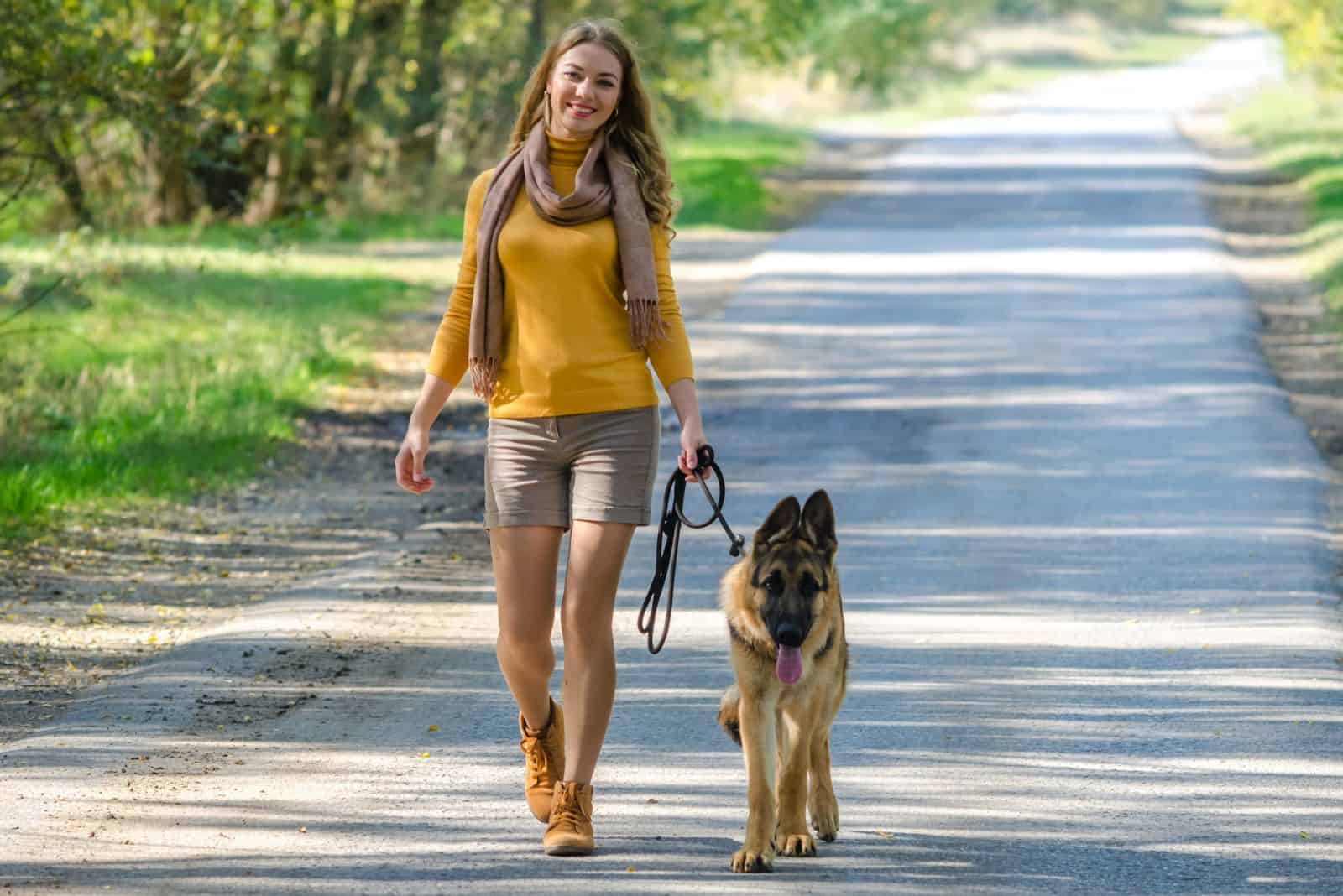 a woman set with a German shepherd