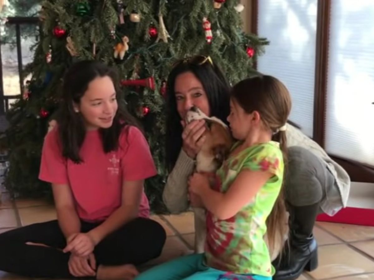 a woman with two little girls and a foster dog