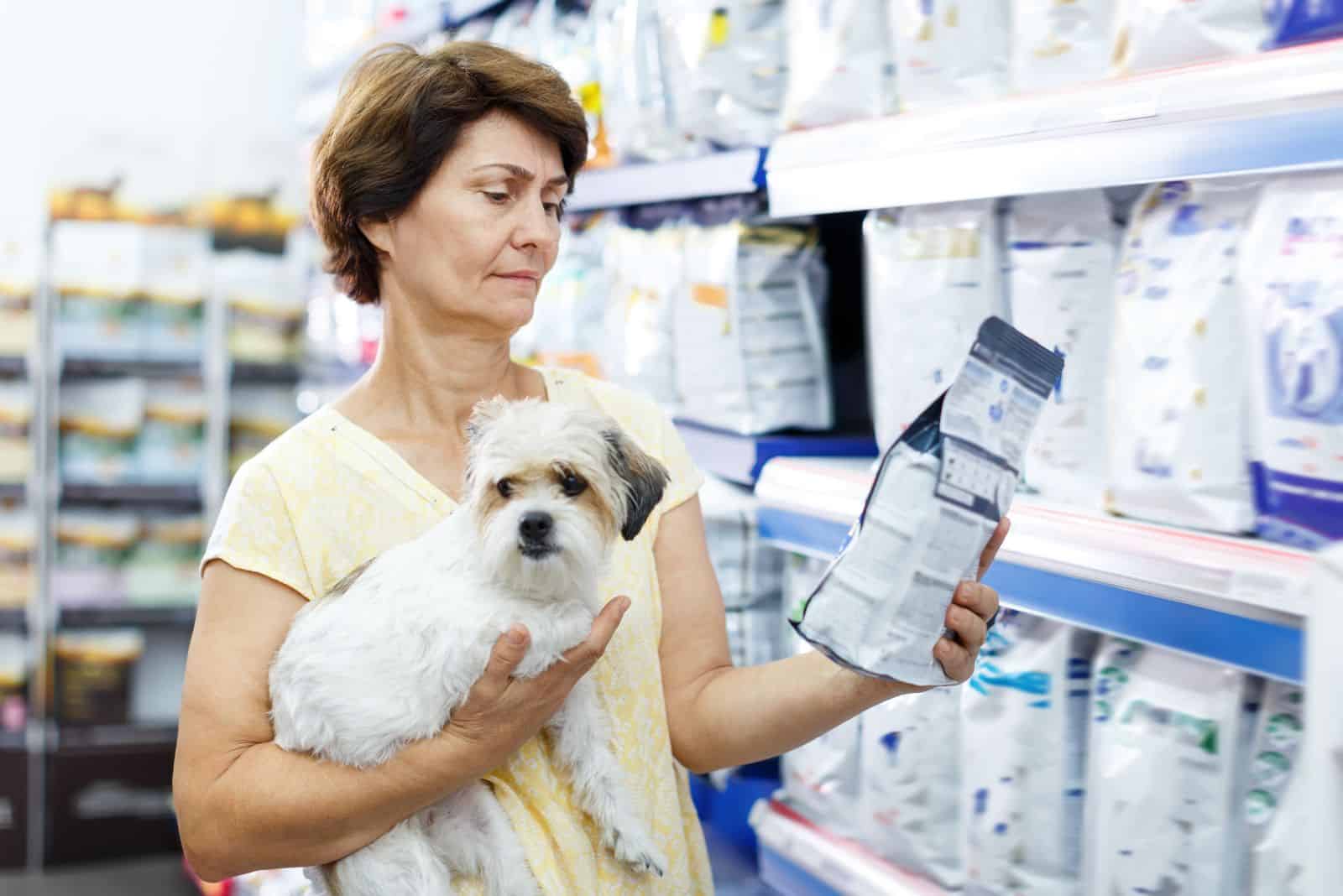 an elderly woman takes food for the dogs