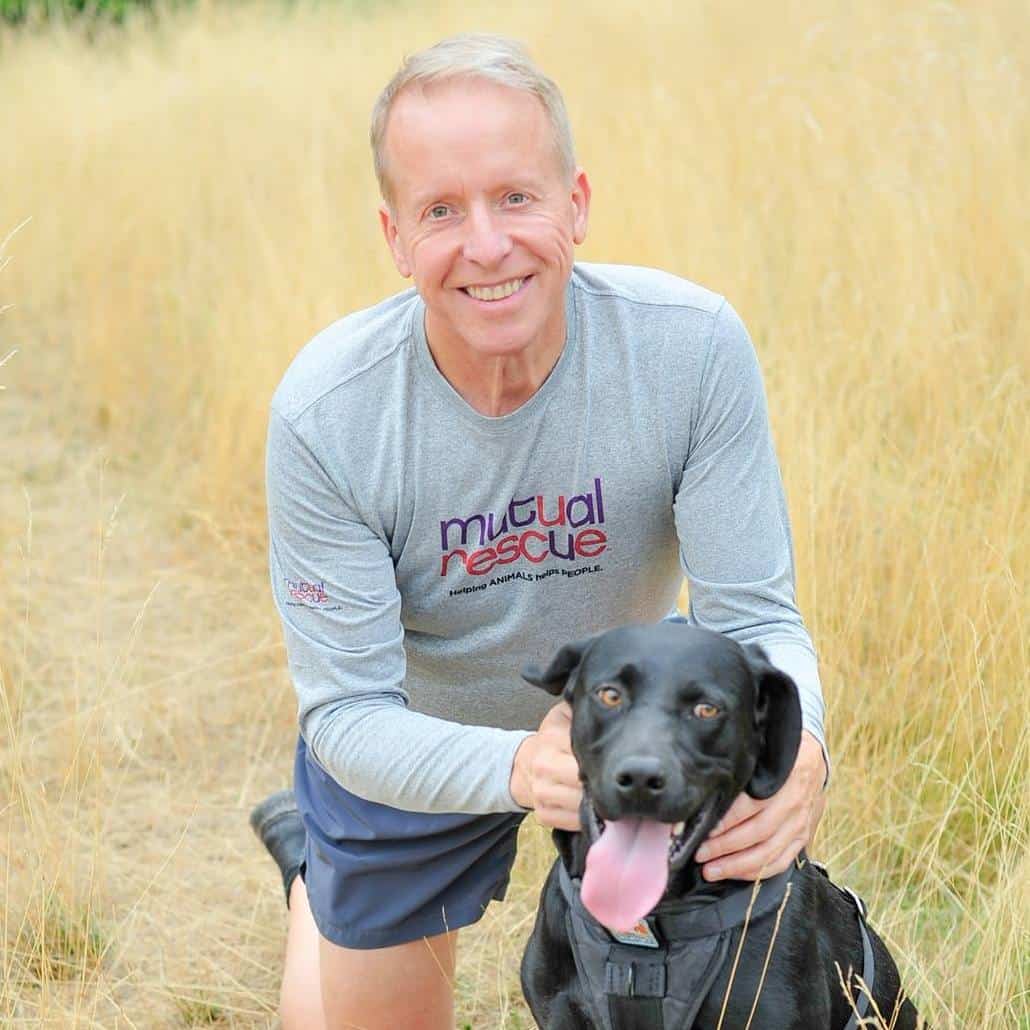 Bald man with black dog