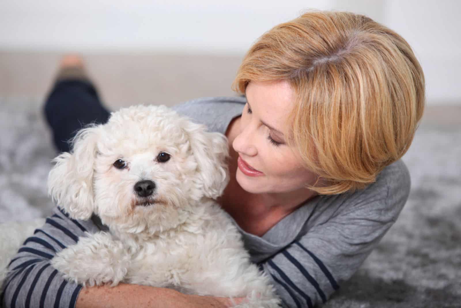 beautiful woman holding a little dog