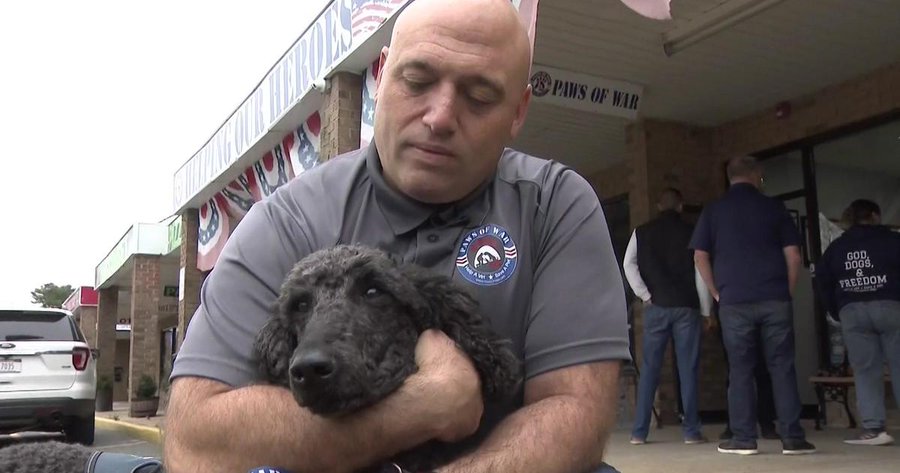 big guy holding a dog