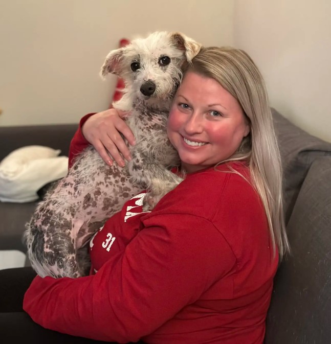 blonde woman holding a dog