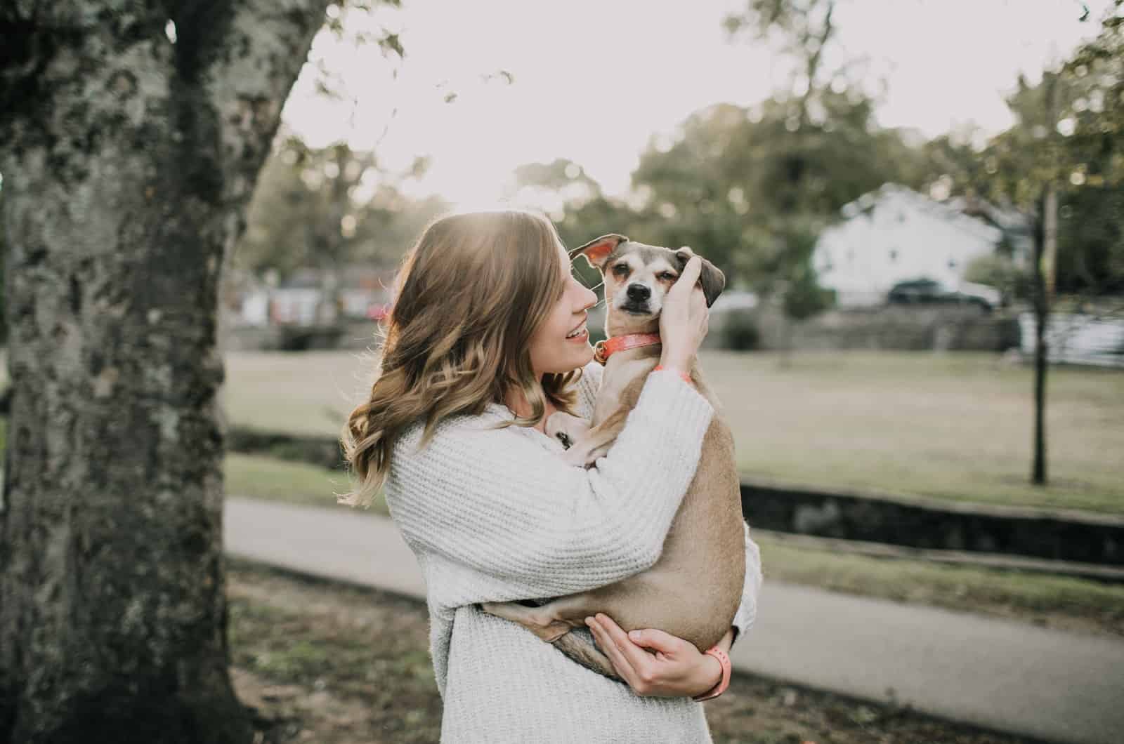 blonde woman holding her dog