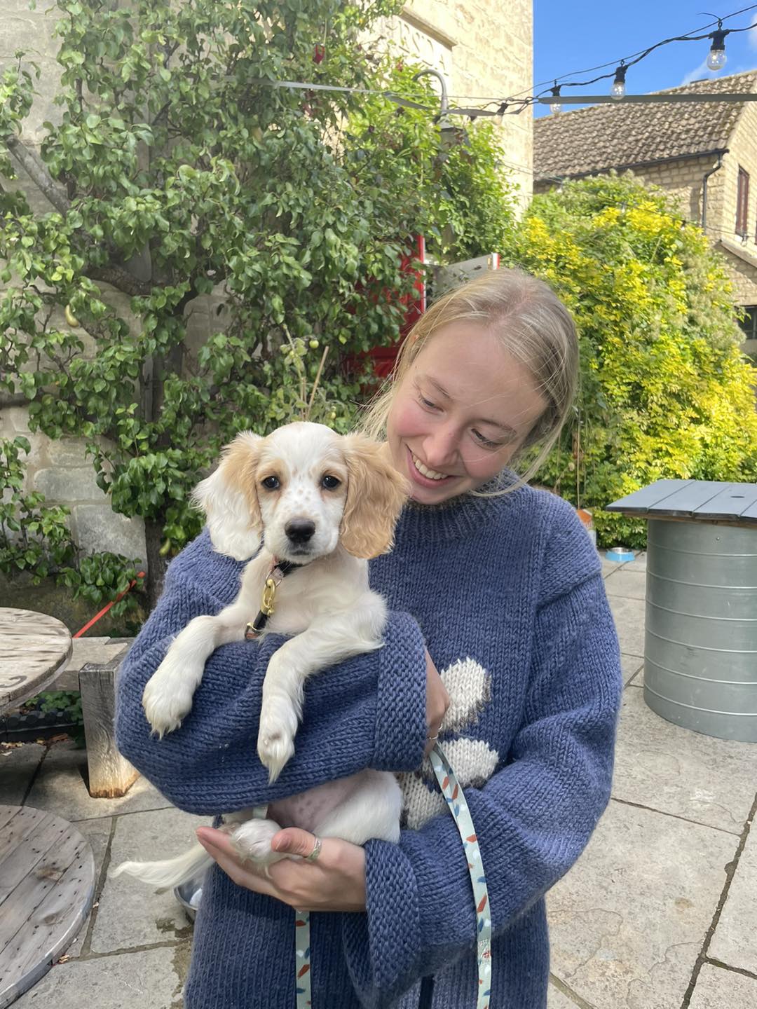 blonde woman holding white dog