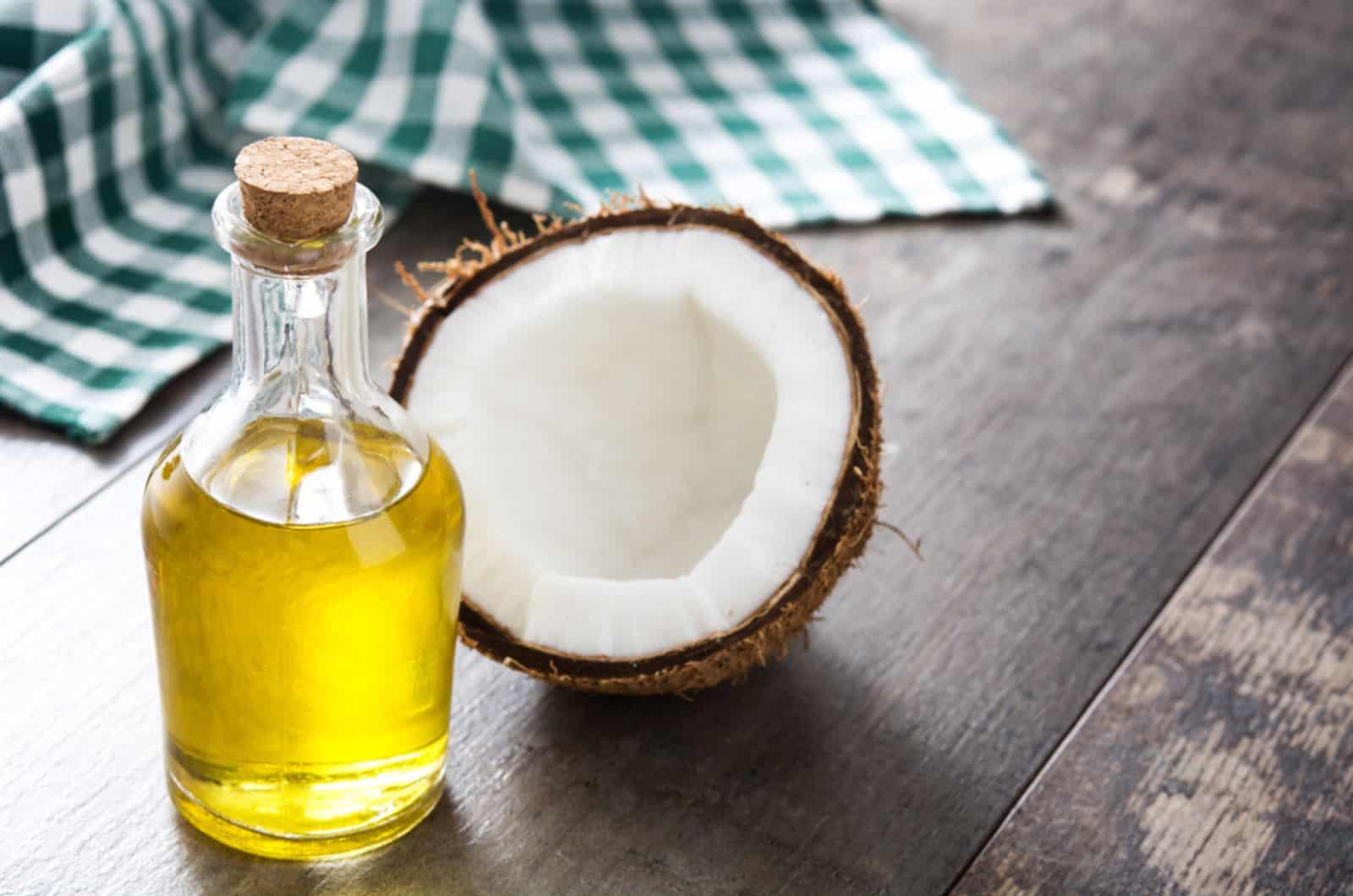 coconut oil and coconut on wooden table