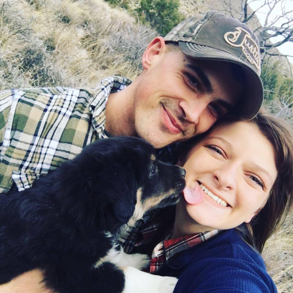 couple and their black dog