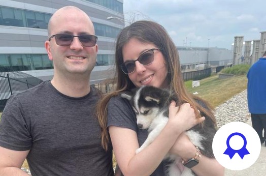 couple holding a dog