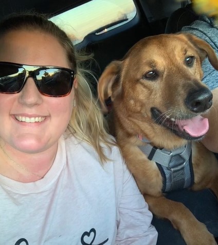 dog and owner sitting in the car