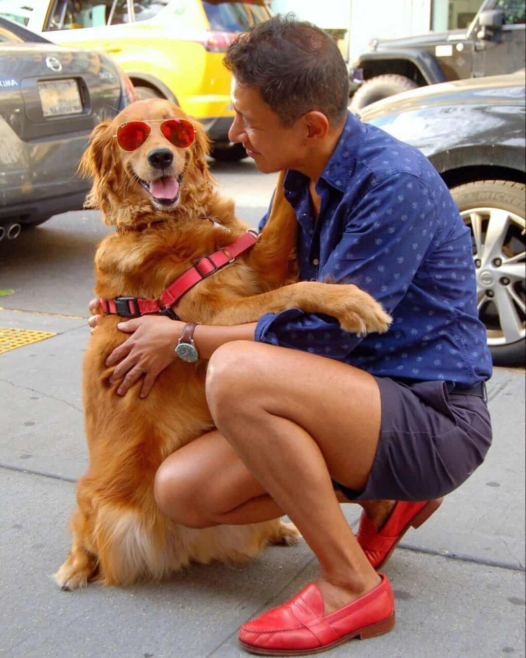 Dog hugging guy with red shoes