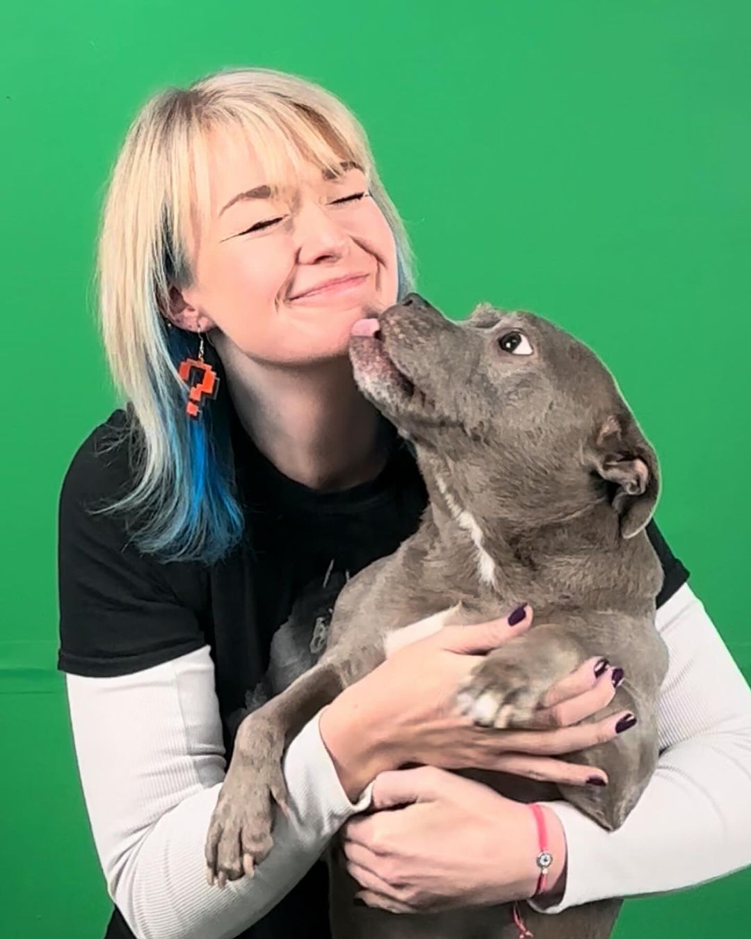 dog licking woman's face