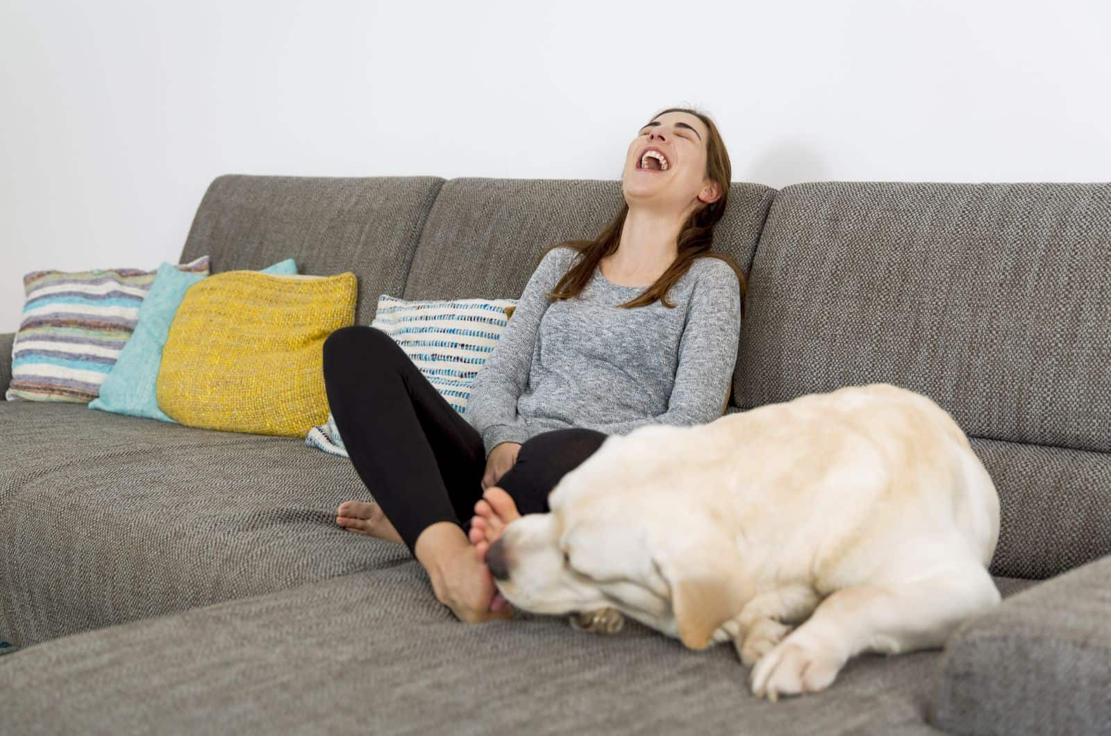 dog licking woman's feet