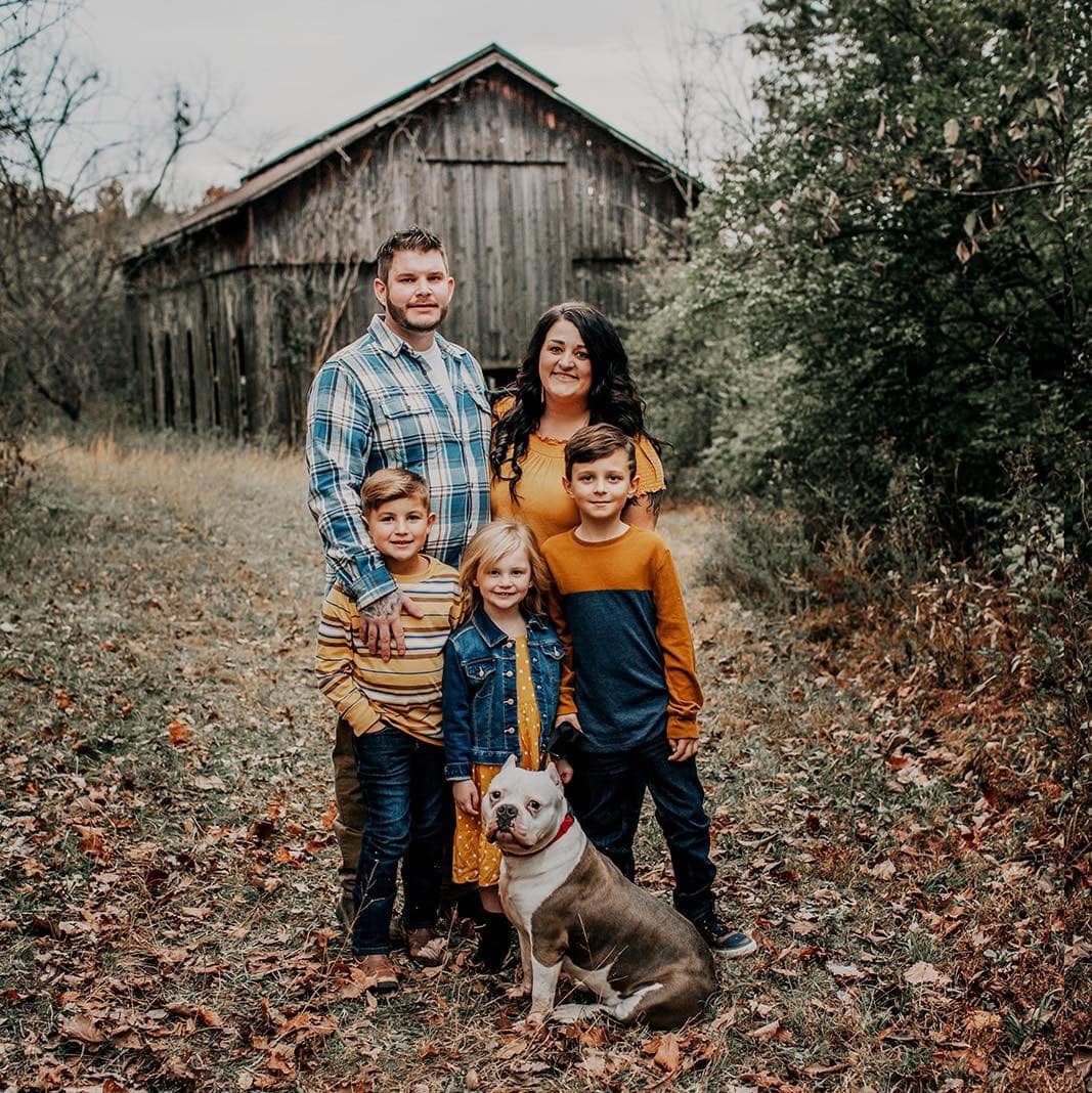 family and dog in a woods