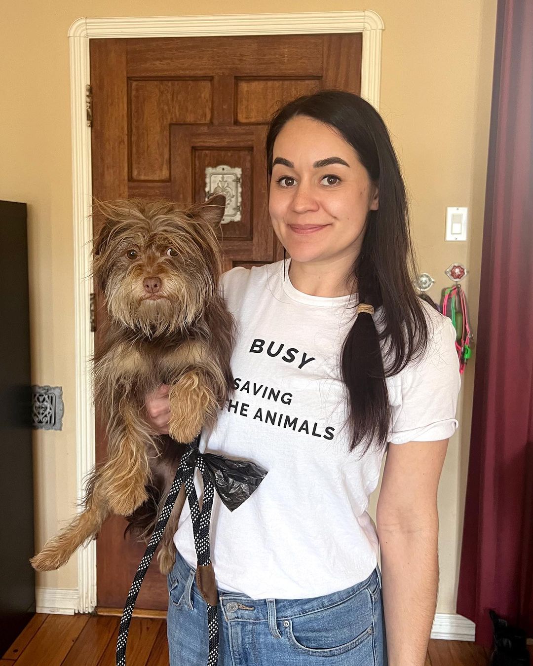 girl holding her brown dog