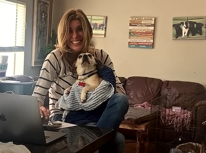 girl holding her white dog