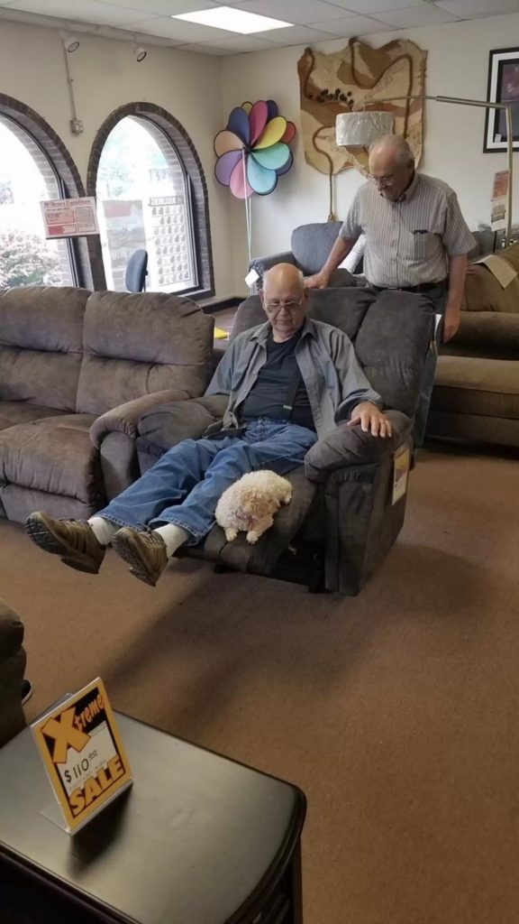 grandfather and dog try out the armchair