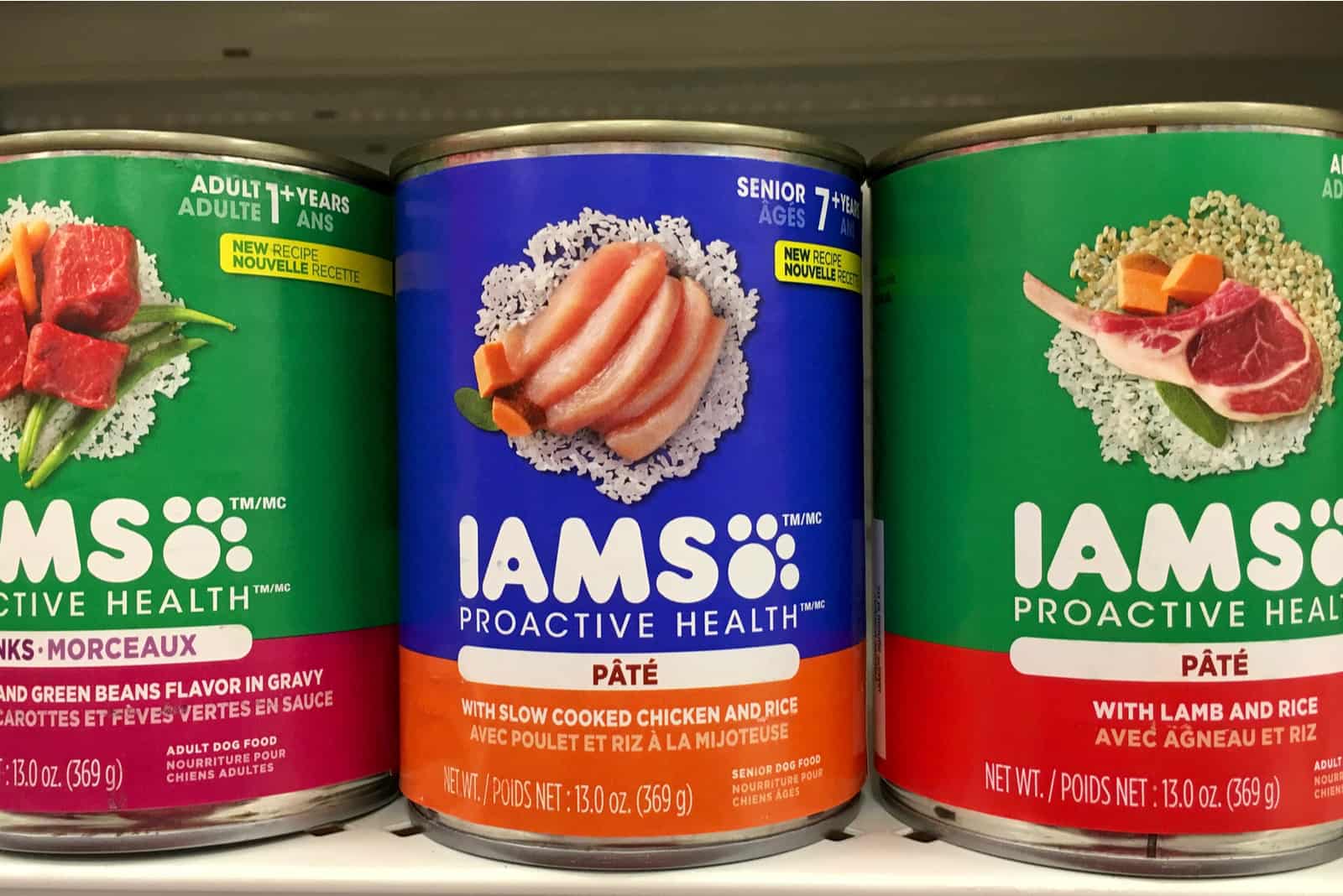 Grocery store shelf with cans of IAMS brand Proactive Health dog food