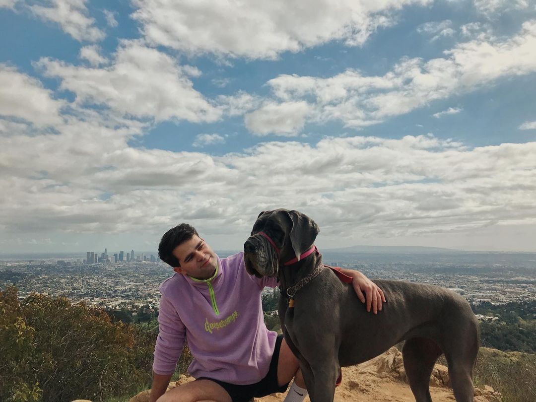 guy and dog standing at city watch out