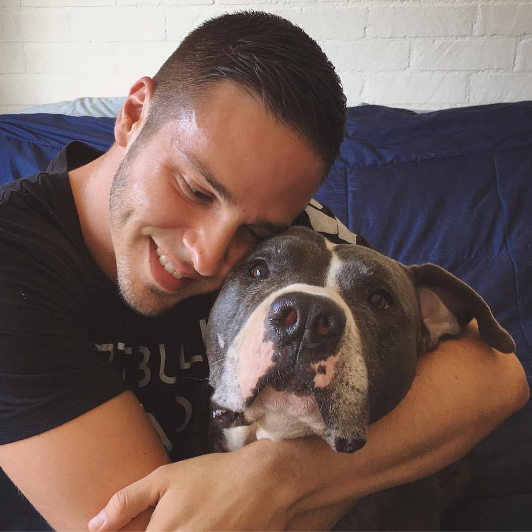 Guy hugging his dog