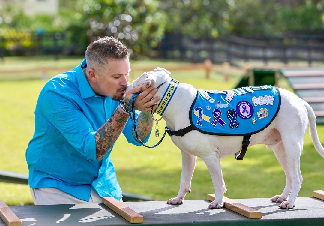 Guy kissing his dog