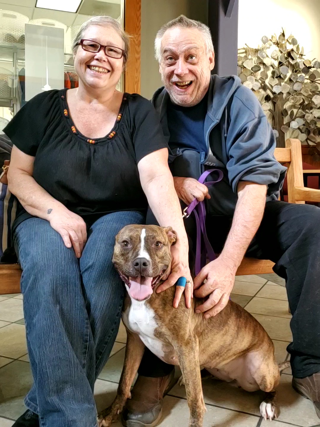 happy couple with their new dog