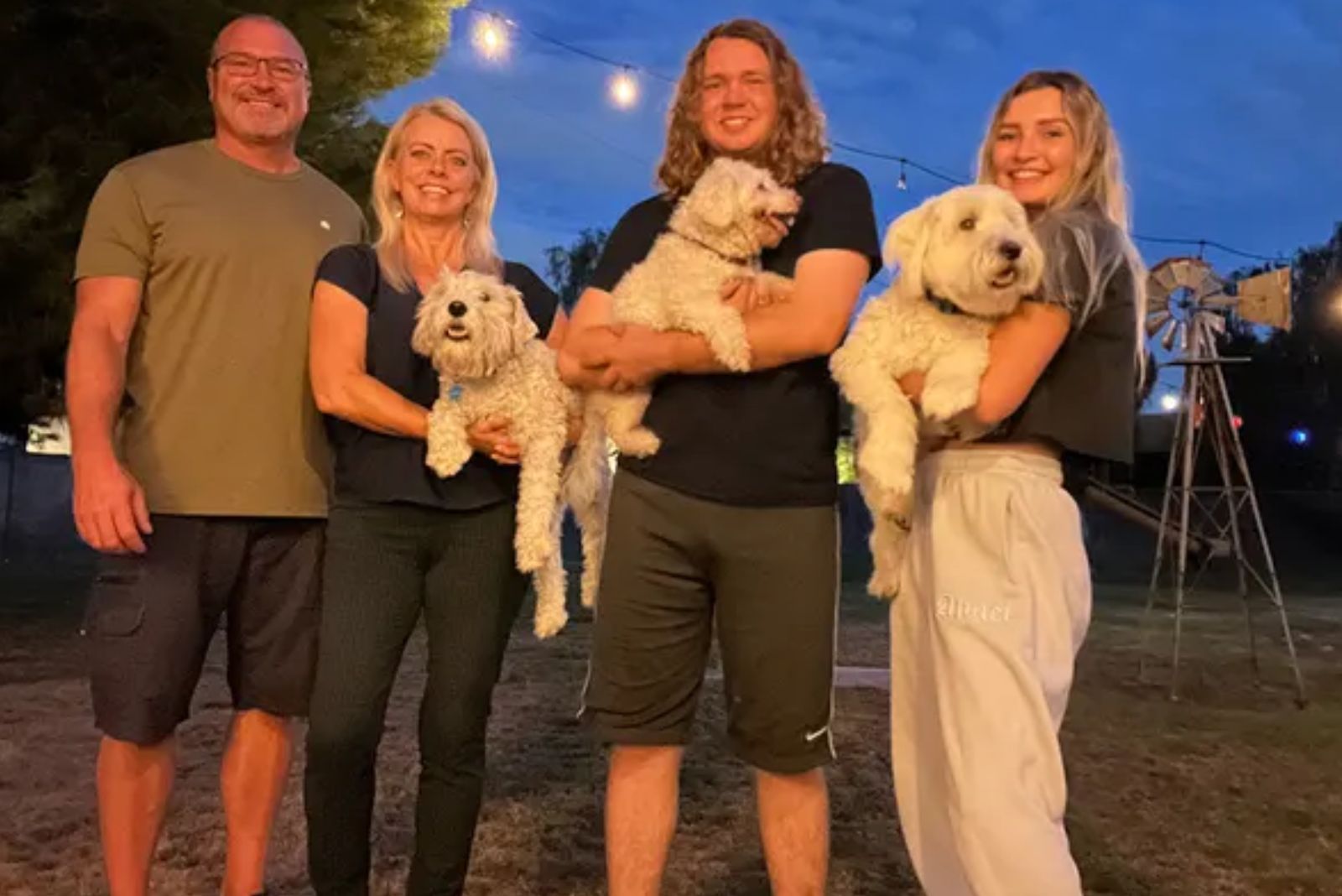 happy people holding dogs