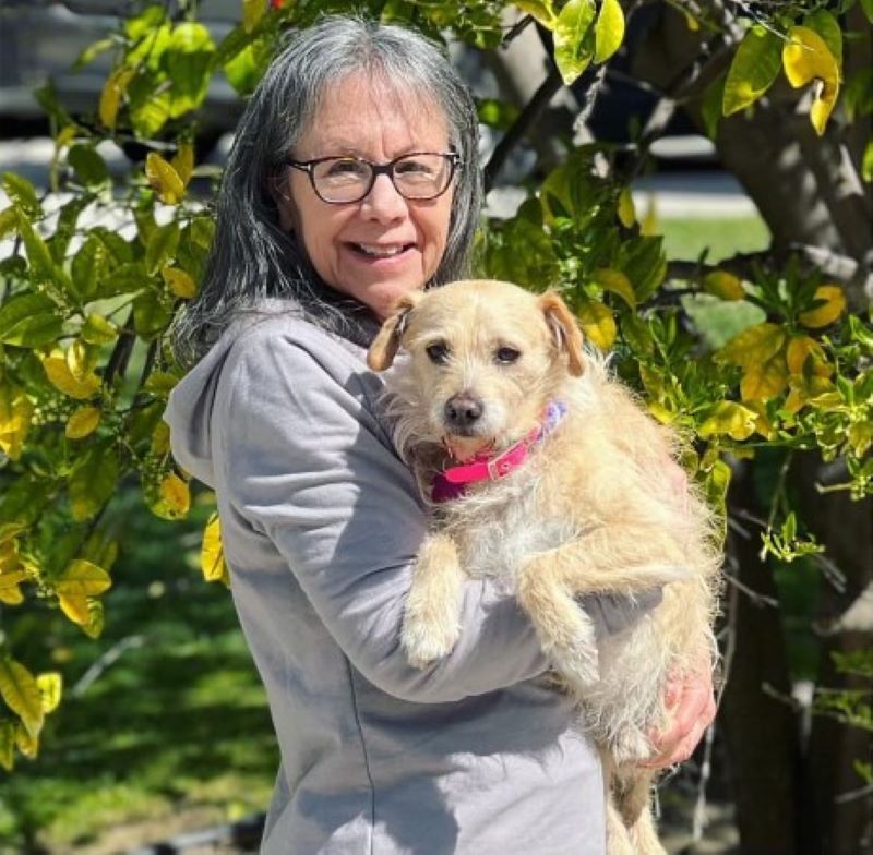 happy senior woman posing with dog