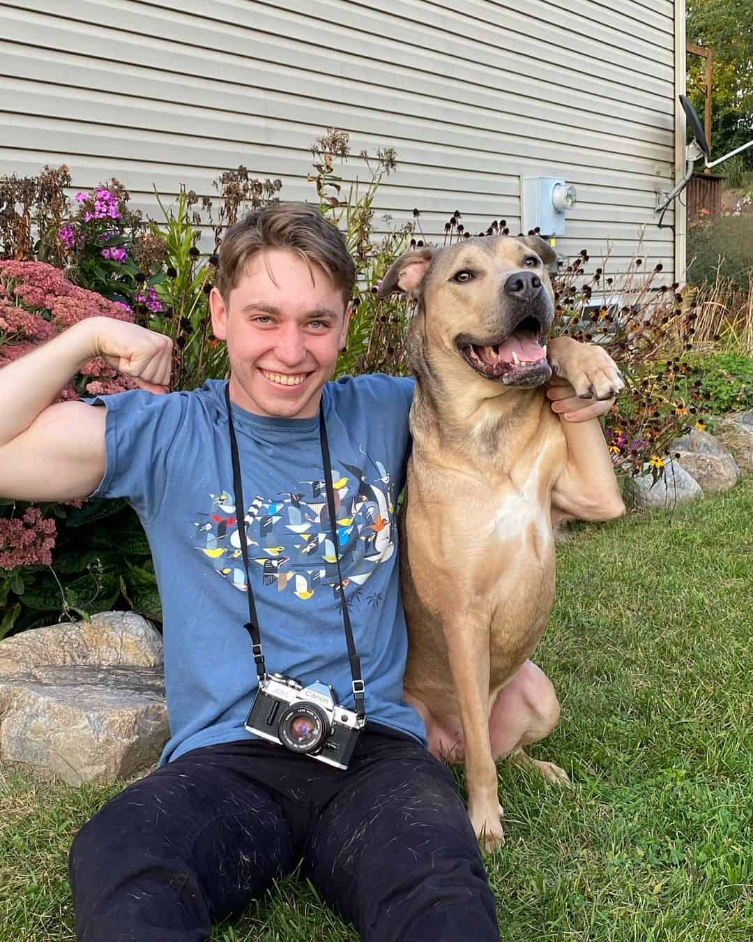 hedgie the dog posing with his owner