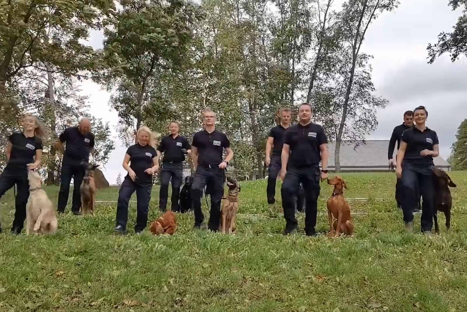 k9 officers dancing with dogs on the lawn