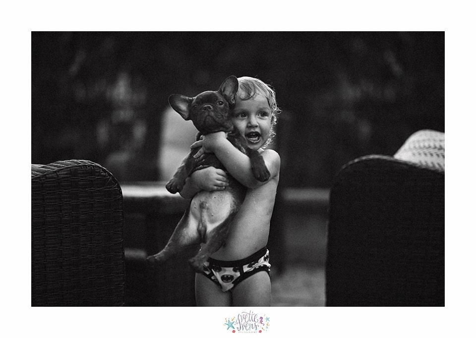 little boy holding a dog