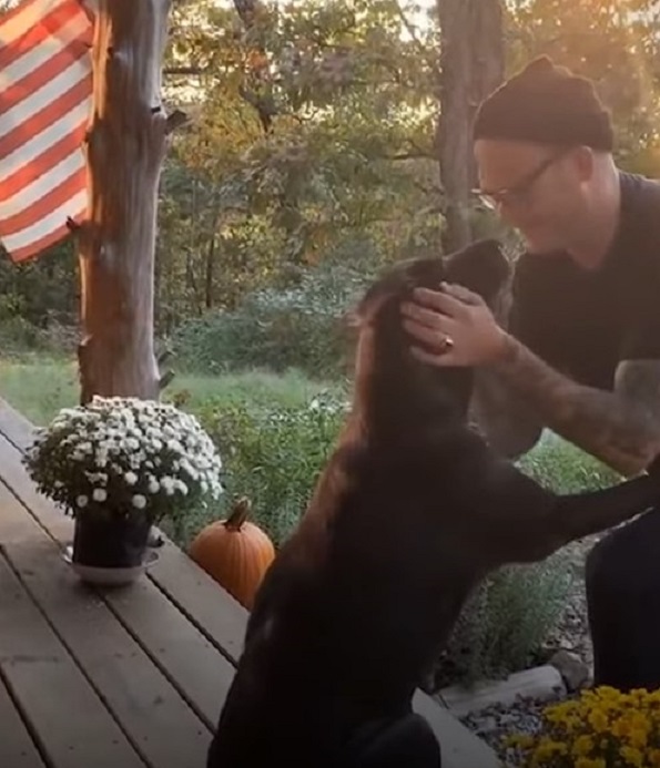 man and a dog on a porch