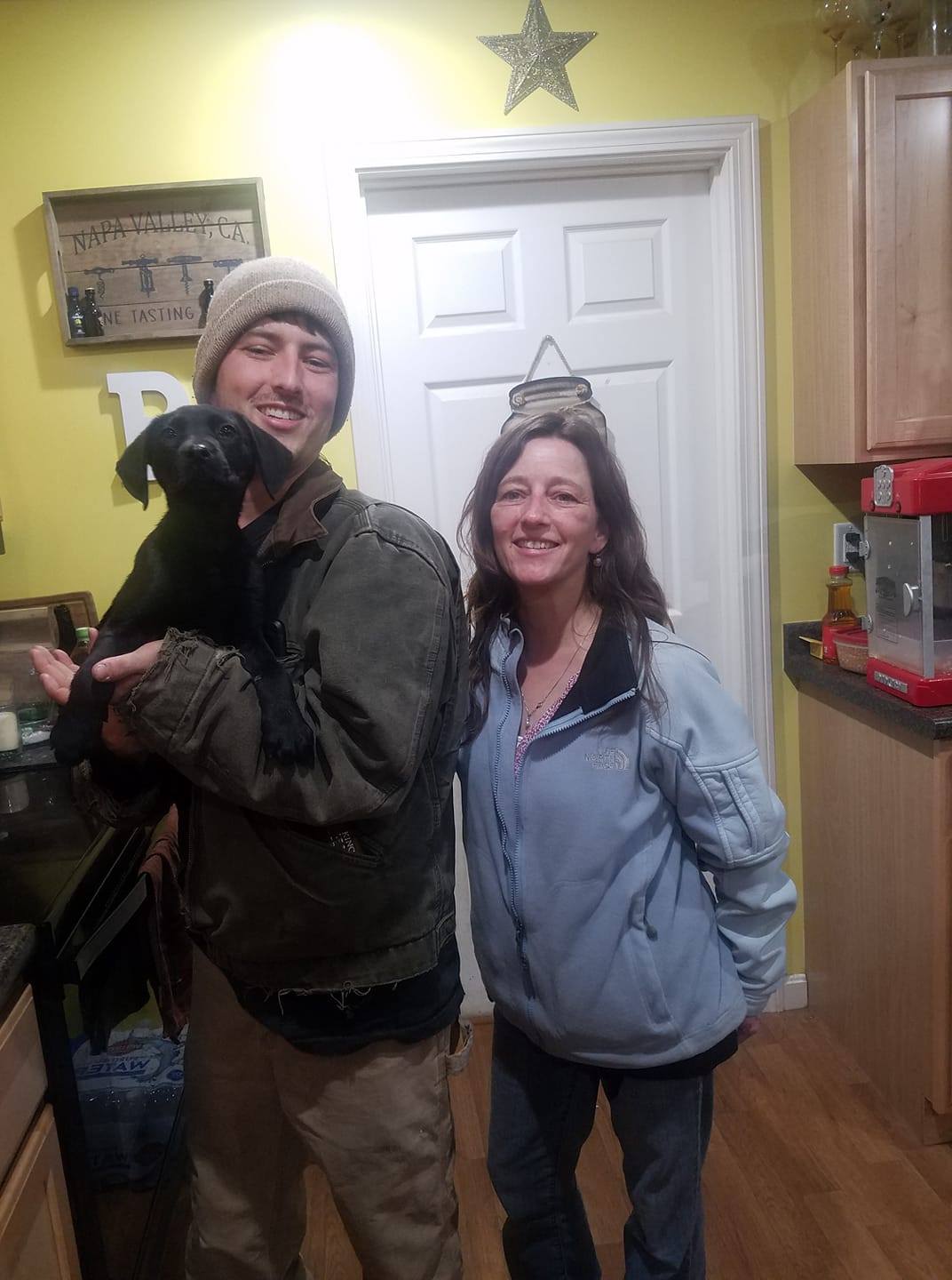 man and a woman with a deaf dog