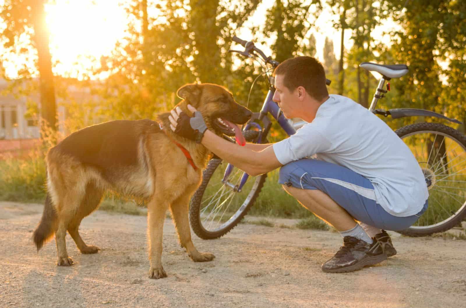 man and his german shepherd dog in the park