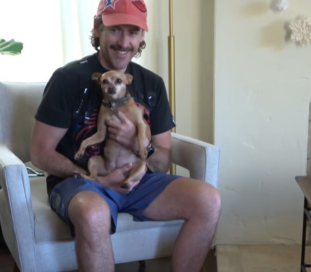 man holding chihuahua