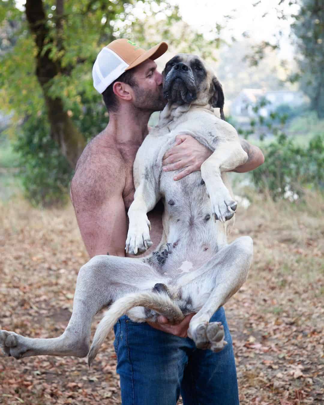 Man holding his dog in his arms