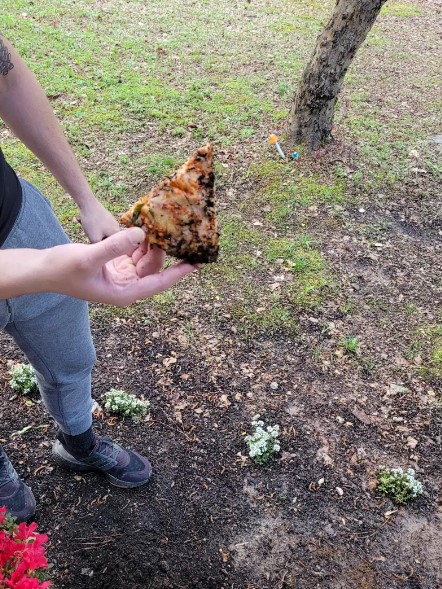 man holding pizza slice