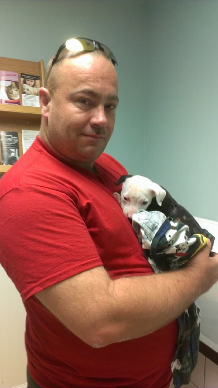 man holding puppy in his arms