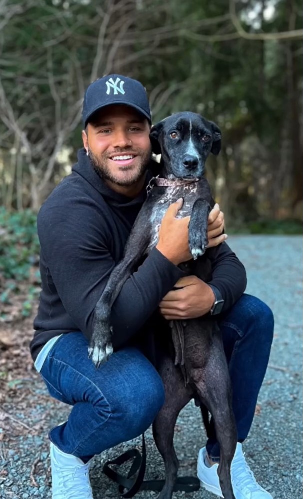 man hugging a dog