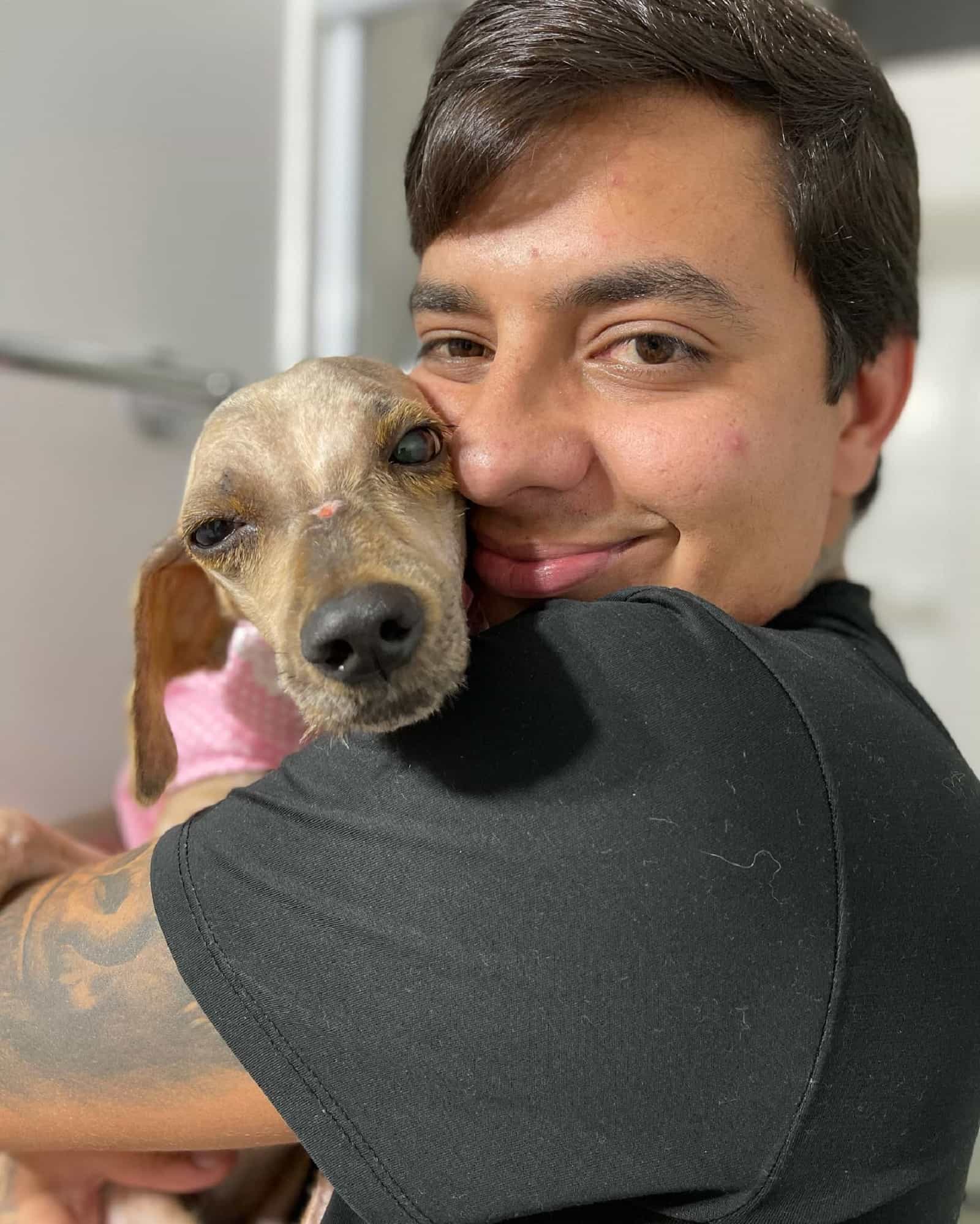 man hugging a puppy he rescued