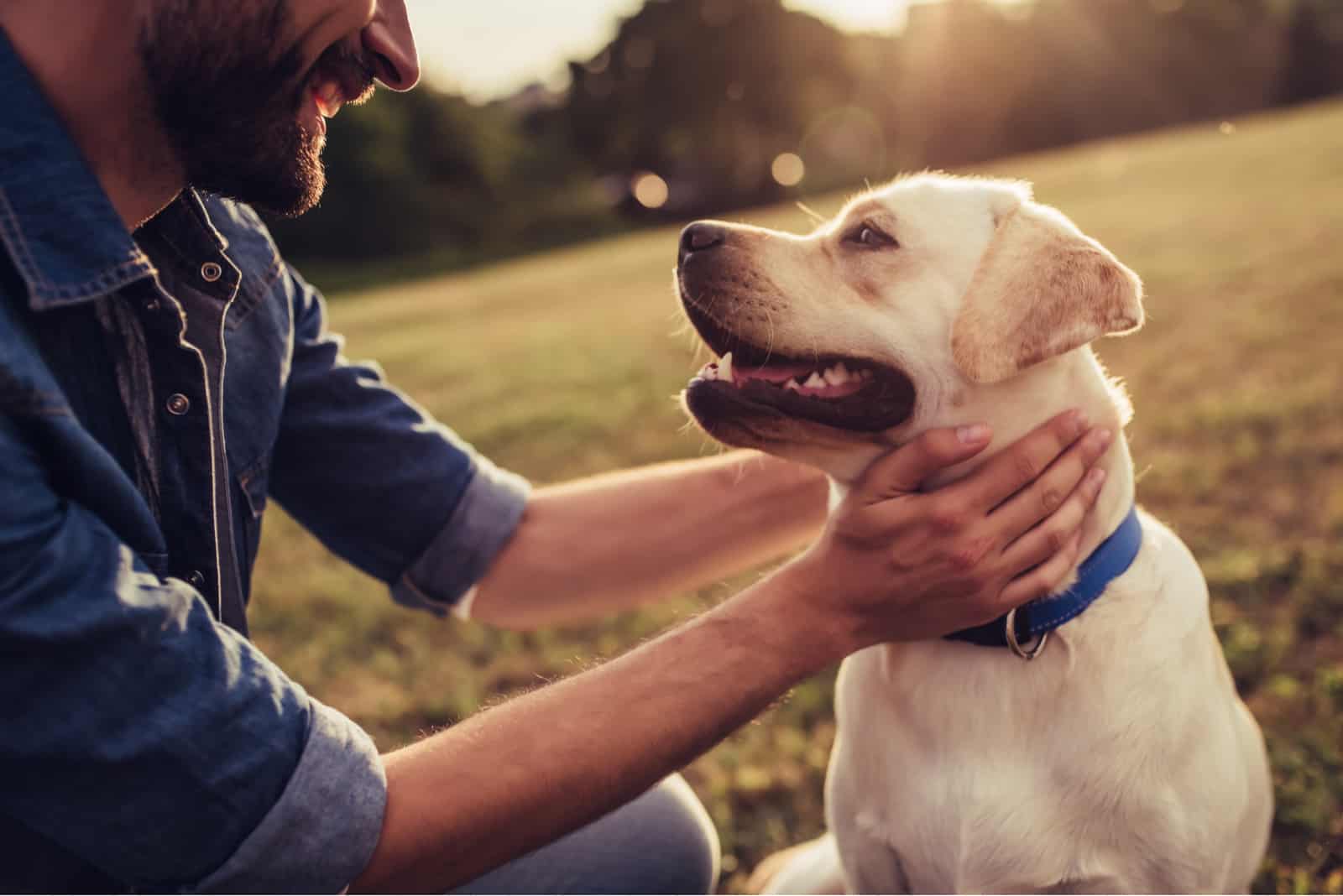 man petting his dog