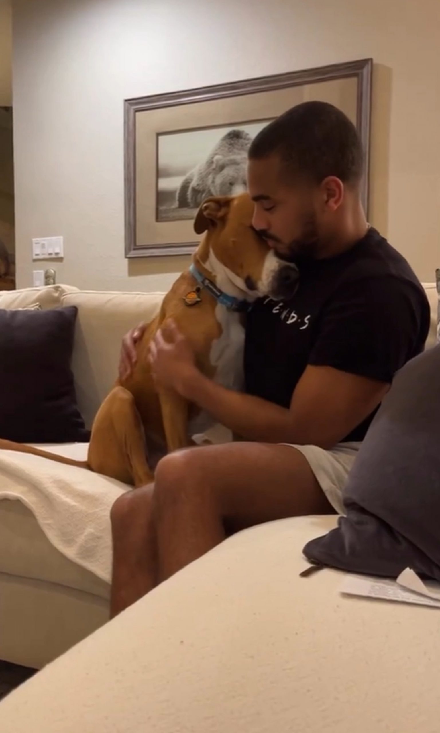 man sitting on couch with a dog