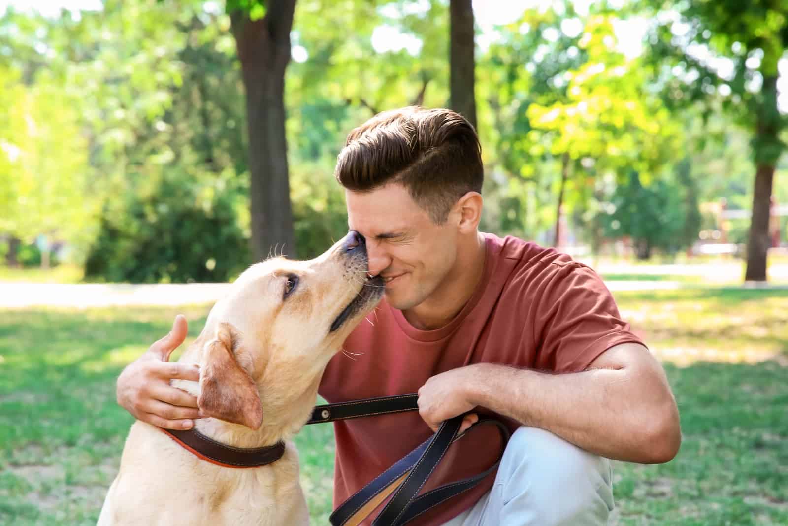 man with retriever in park