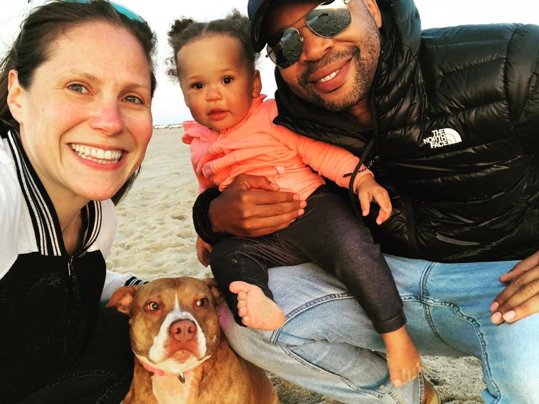 man, woman, baby with a pitbull