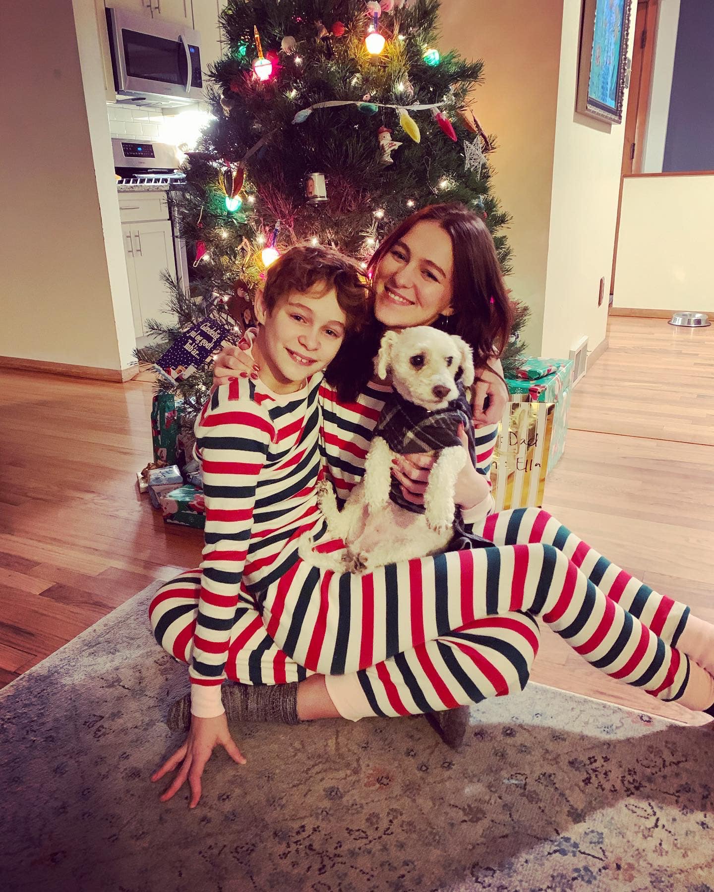 mother, kid and dog near Christmas tree