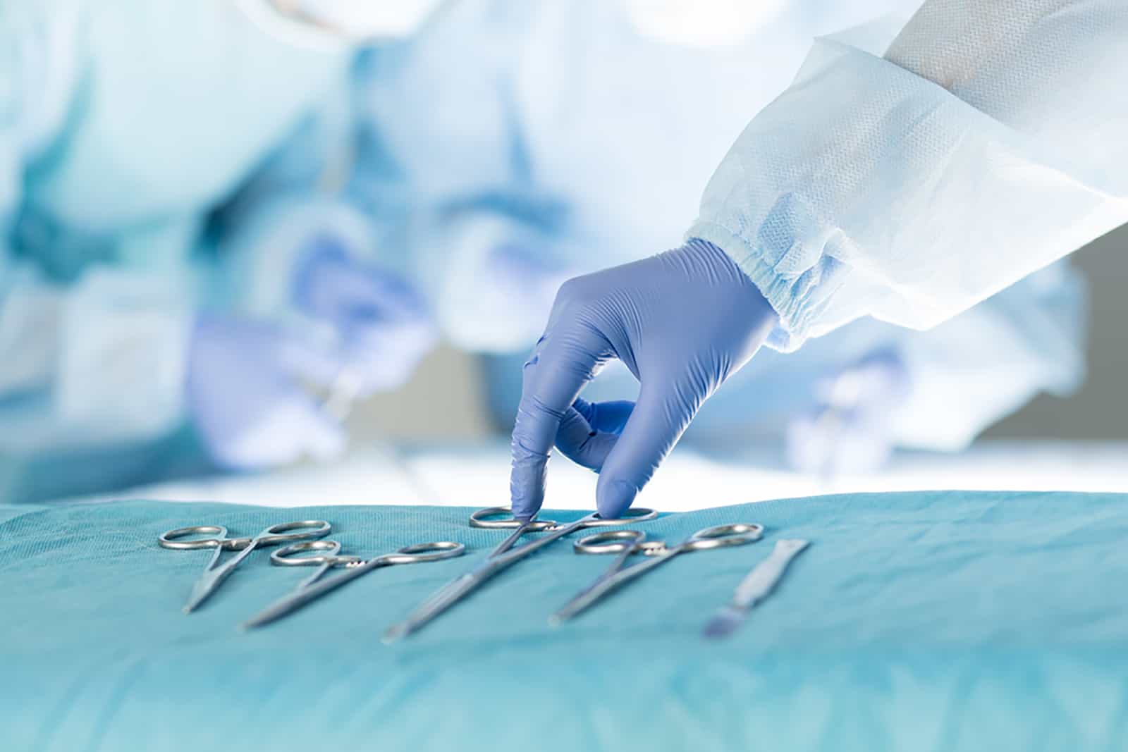 nurse taking medical instruments for operation